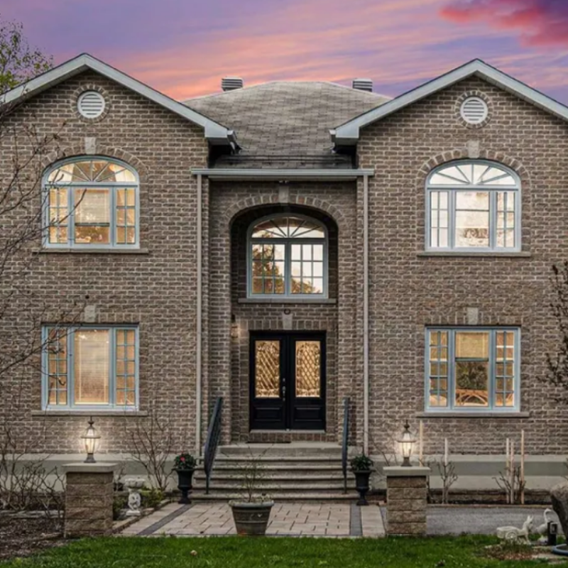 Front view of 4633 Albion Road, Ottawa — a spacious detached home with wide driveway, mature trees, and large lot.