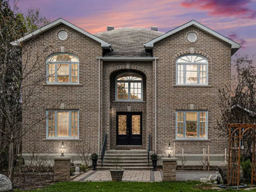 Front view of 4633 Albion Road, Ottawa — a spacious detached home with wide driveway, mature trees, and large lot.