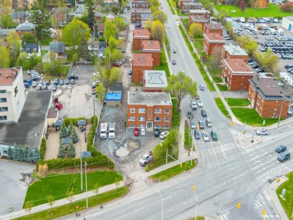 Group of property management professionals working together in a modern office environment, discussing real estate strategies.