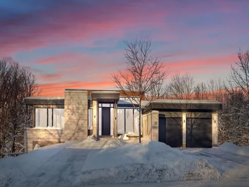 Contemporary multi-storey apartment building with balconies and large windows, located in Ottawa’s urban neighborhood.