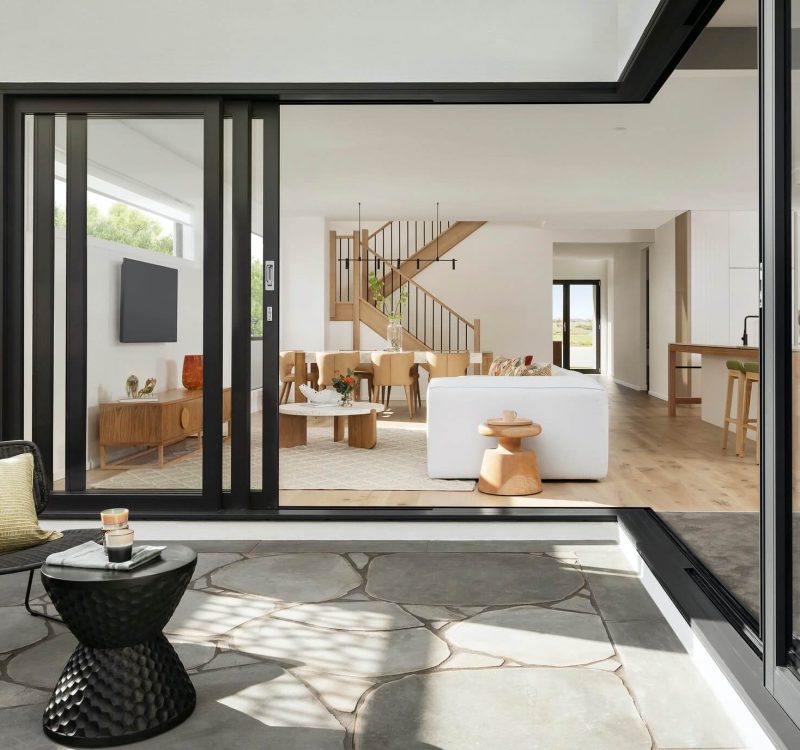 Stylish modern house exterior featuring geometric lines, minimalist design, and expansive glass elements.